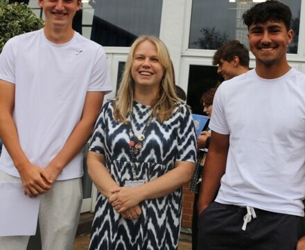 Patrick Loftus, Head of PE Anne Baxby and Benji Ratcliffe celebrate getting into Lloughboriguh